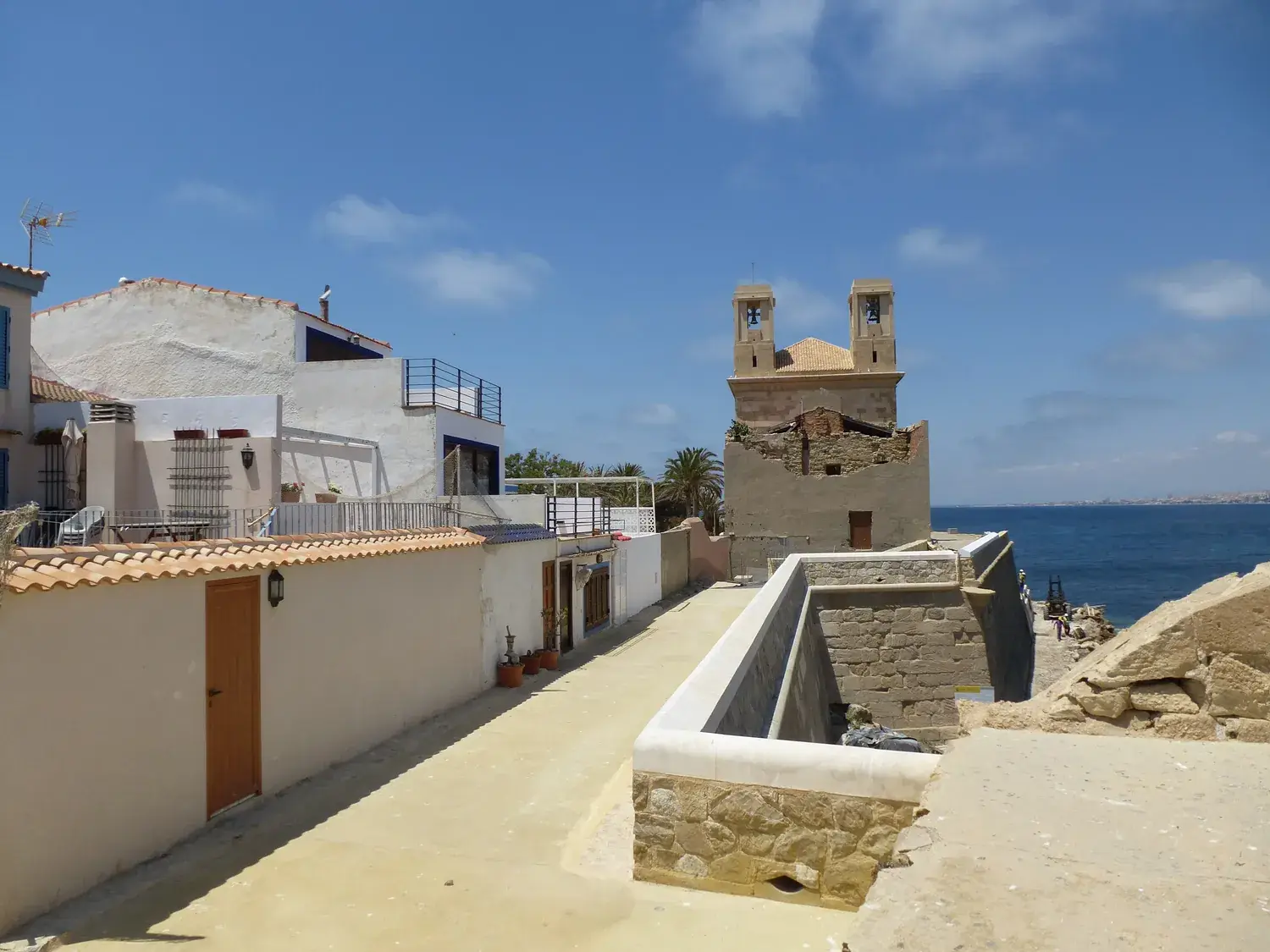 Street in Tabarca with low houses and the church bell tower
