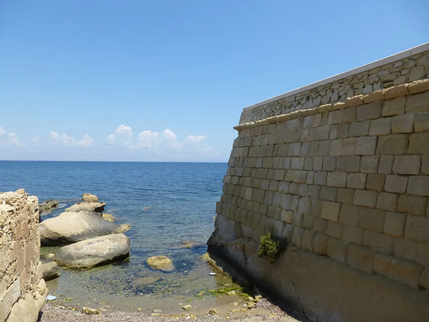 Tabarca’s stone ramparts dropping into a clear sea
