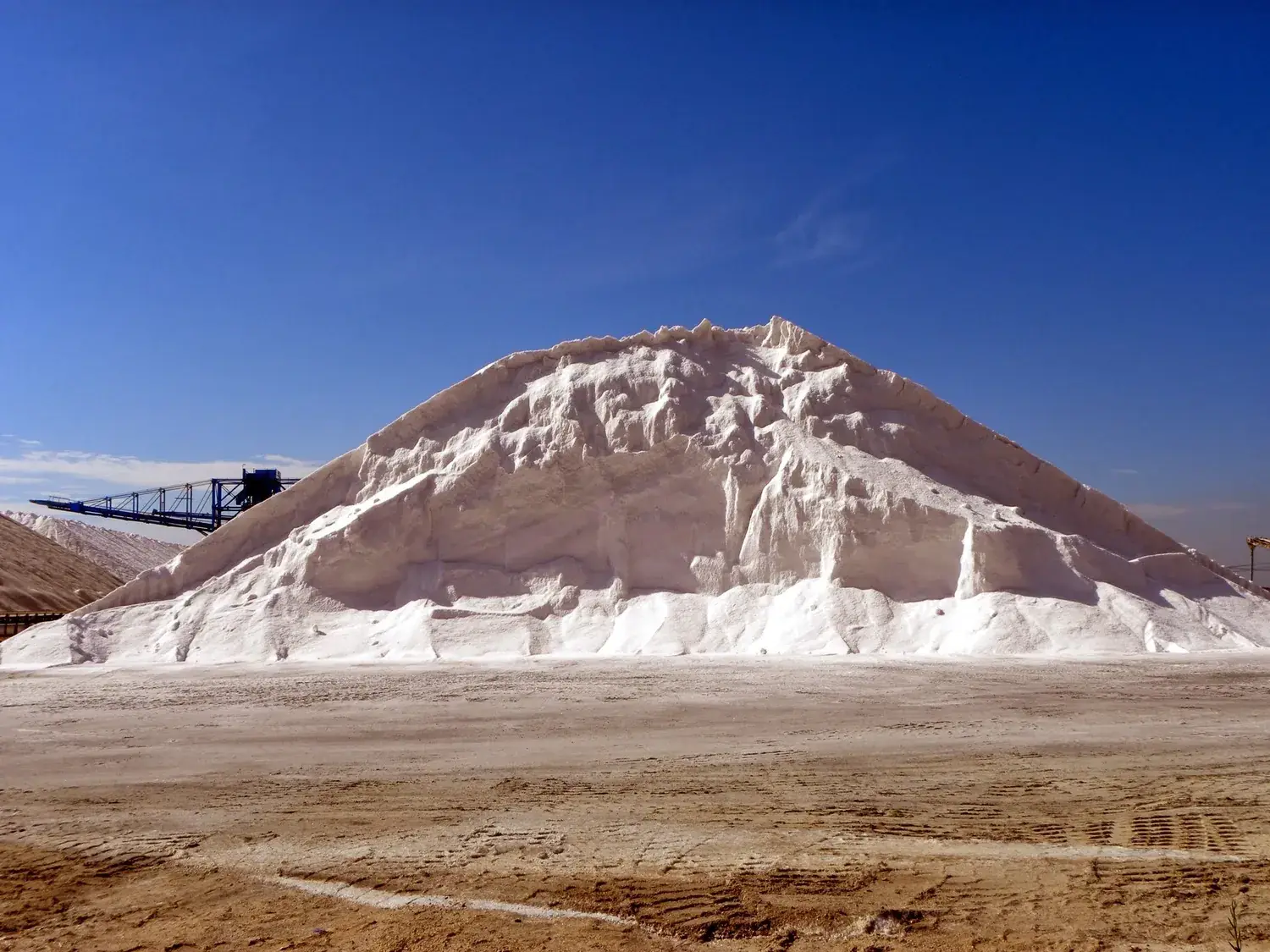 Large white mountain of salt beside the Santa Pola salt flats