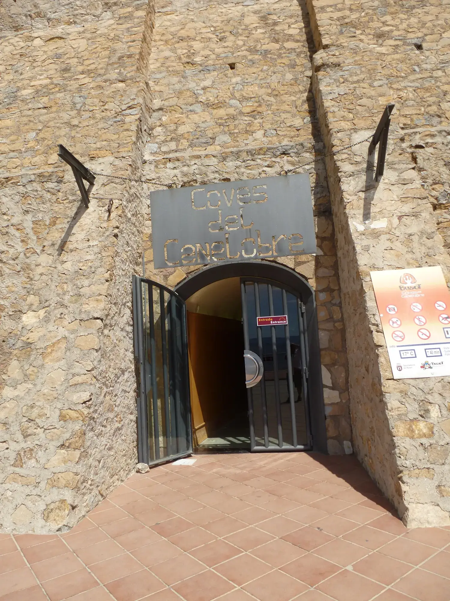 The rock-cut entrance to the Canelobre caves, with a gate