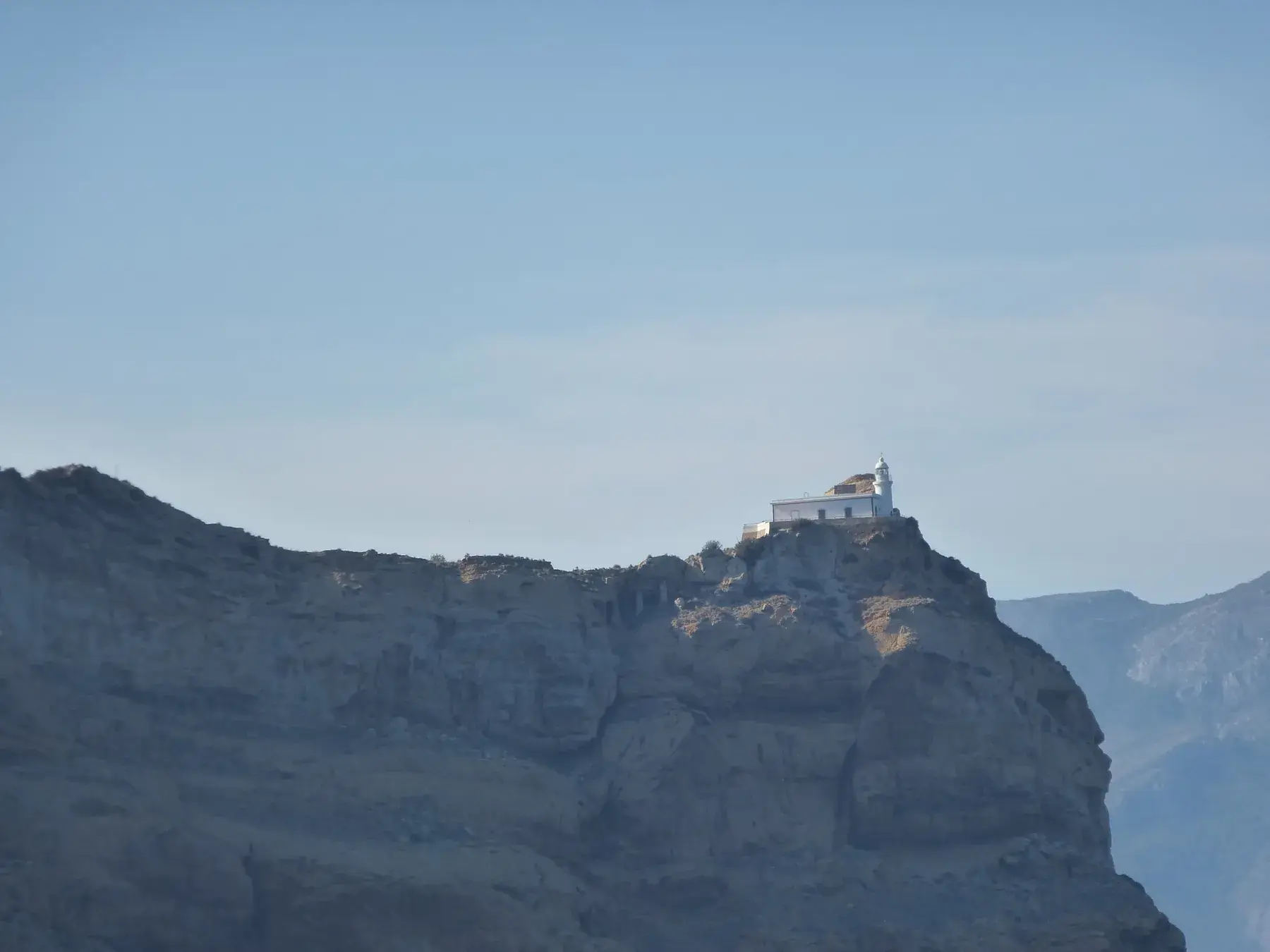 The Albir lighthouse perched on the Serra Gelada cliffs above the sea