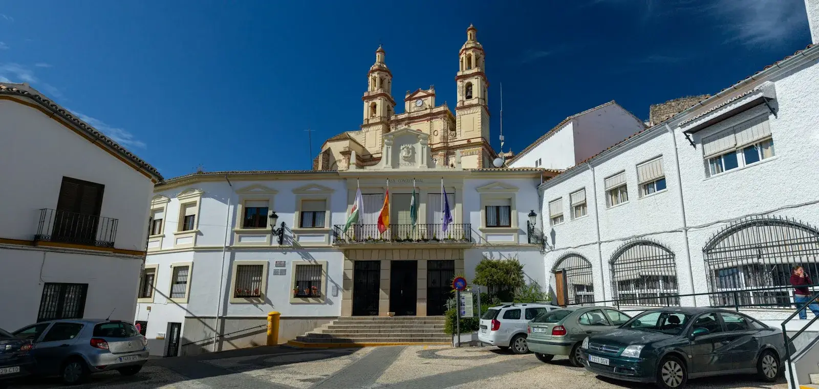White façade of a Spanish town hall under a blue sky