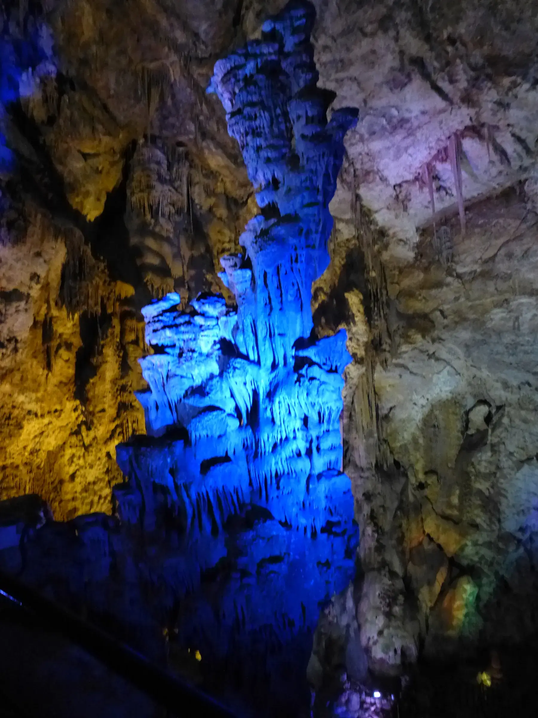 Stalactites and formations lit in blue in the great hall of the Canelobre caves