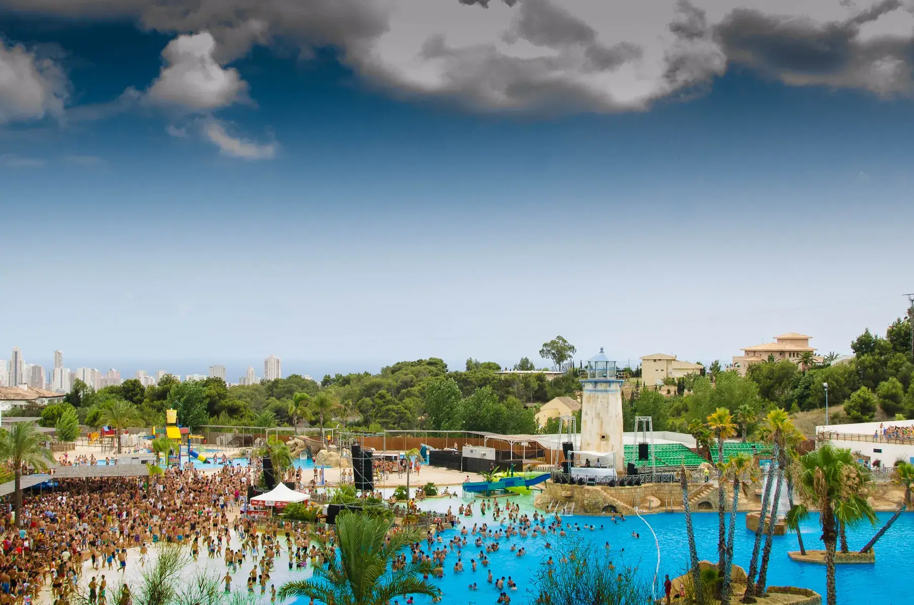 View from above of the Aqua Natura wave pool, its lighthouse and Benidorm’s towers in the distance