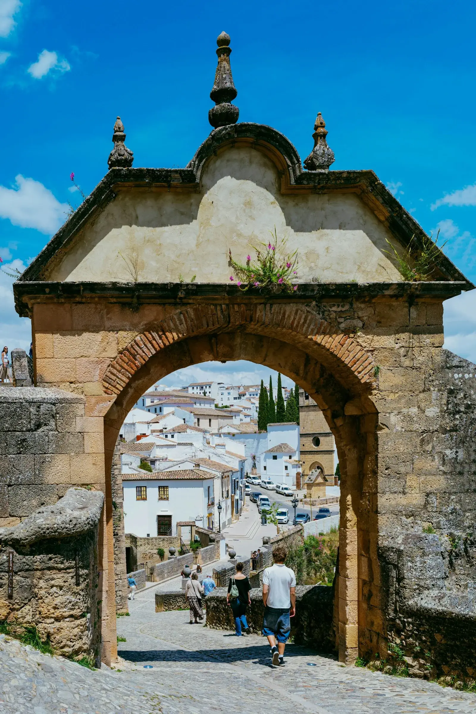 Stone arch opening onto a village of white houses