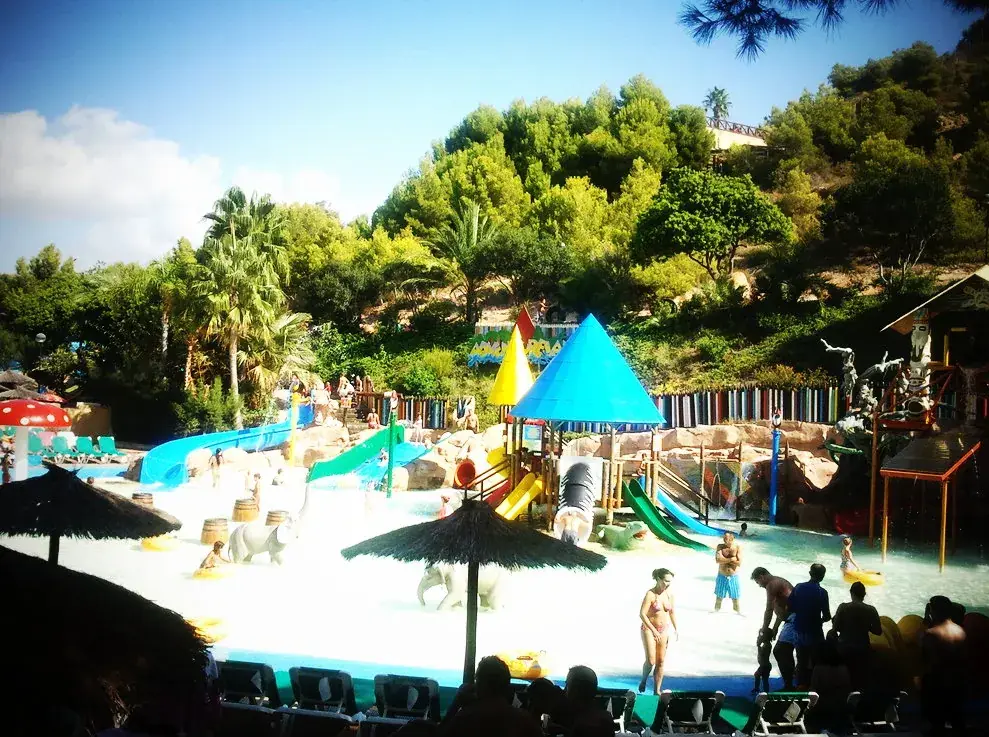 Aqualandia’s children’s splash area, with colourful slides beneath the pine trees